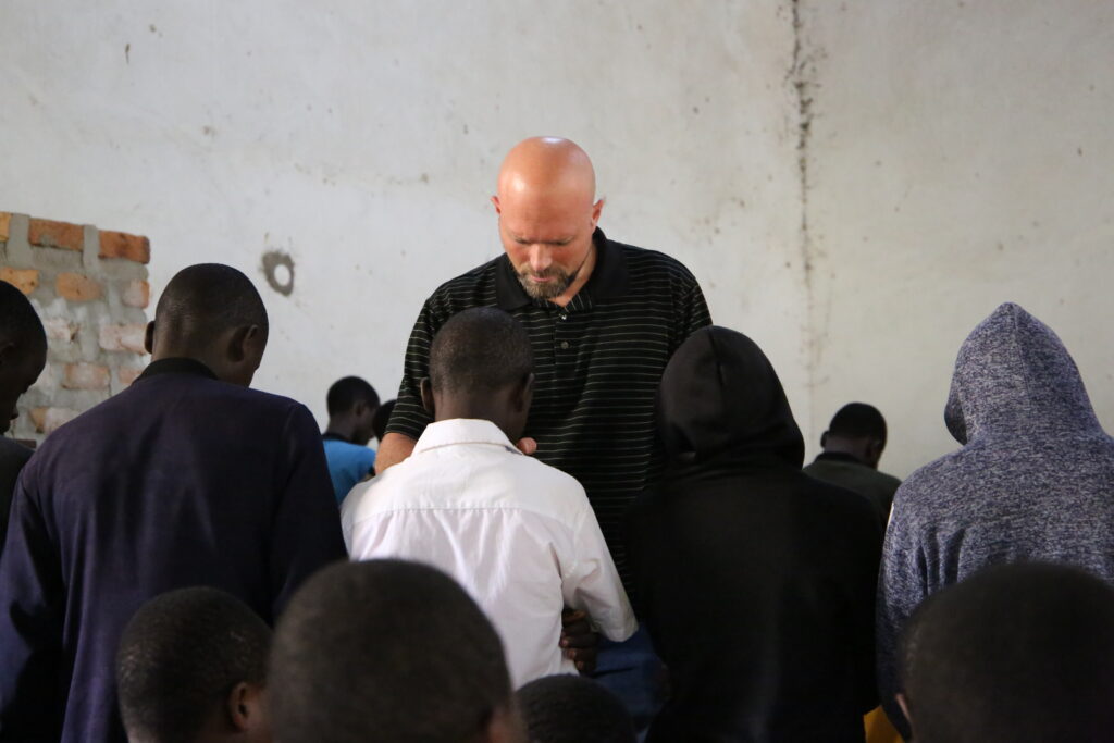 Praying for students during chapel at the Yesu Akwagala High School.